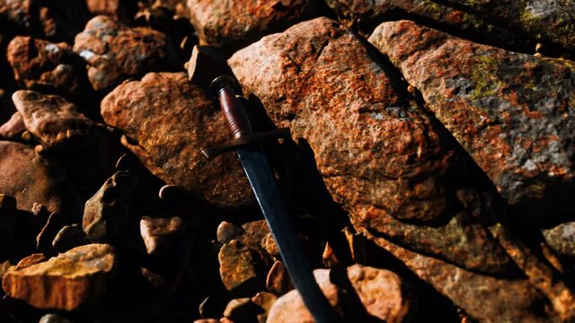 old dagger on the rock at sunset
