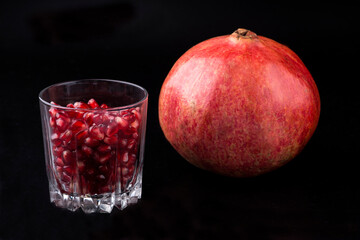 Red background of red pomegranate grain. Large ripe red pomegranates. The fruits of a red ripe...