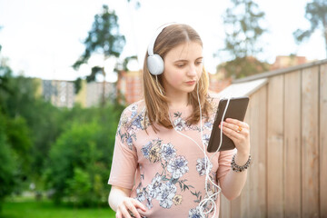 A young girl Looks into her mobile phone, reads a message