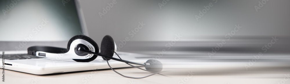 Poster headset on laptop computer keyboard.