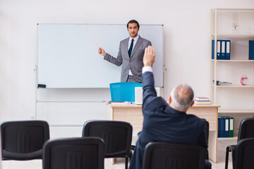 Two businessmen in the classroom in pandemic concept