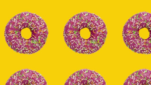 Pink rotating donuts in geometric pattern on a yellow background. Minimal motion graphics food concept animation