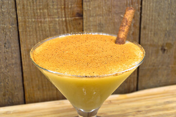 Boza and cinnamon sticks, traditional Turkish cuisine drinks, on wooden background