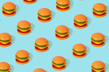 Creative trendy idea fast food pattern-  Hamburger on bright blue background.