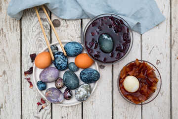  Coloring Easter eggs with environmentally friendly dyes, hibiscus tea, egg husks, turmeric.  View from above.