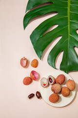 Fresh lychees on pink table in studio