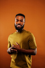 young pretty african american man posing cheerful on brown background, lifestyle people concept