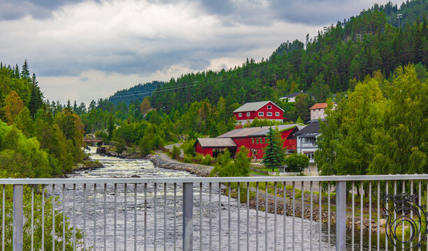 Idyllic red houses and river in Fagernes Fylke Innlandet Norway.