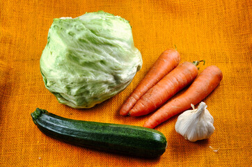 composition of organic vegetables (salad, carrots, courgette and garlic)