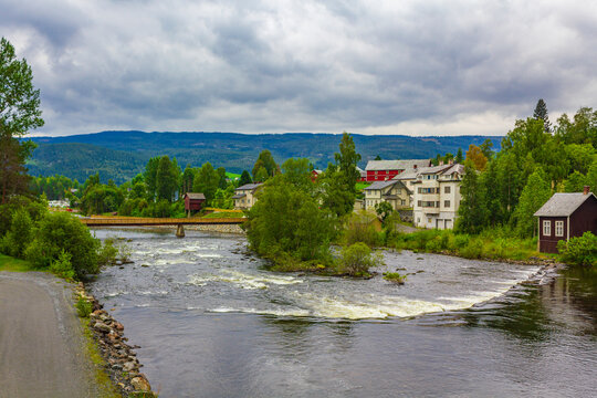 Idyllic red houses and river in Fagernes Fylke Innlandet Norway.