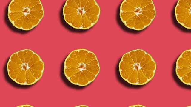 Coral background with mandarin pattern in geometric grid. Minimal motion graphics natural fruit looped animation