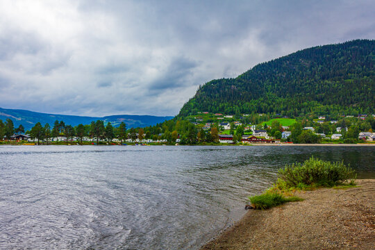 Idyllic red houses and river in Fagernes Fylke Innlandet Norway.