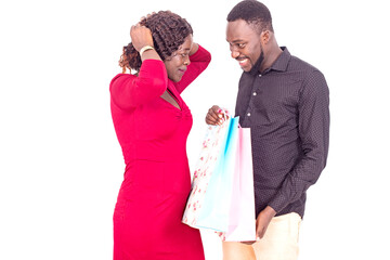 handsome man offering shopping bag to his girlfriend.