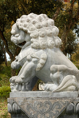 Stone lion statue at Buddha Eden Garden landscape, Portugal