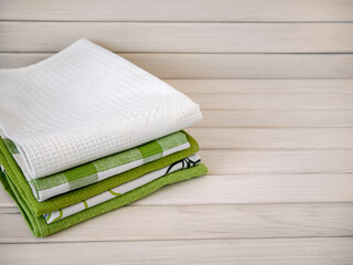 A pile of neatly folded towels on wooden background. Production of natural textile fibers.Organic product. Natural cloth