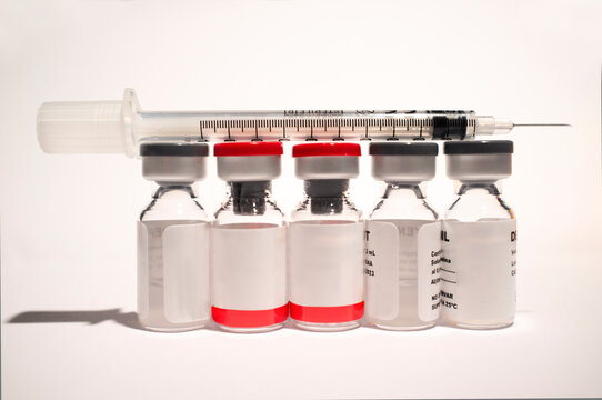 Uncovered syringe and vaccine ampules or glass vials