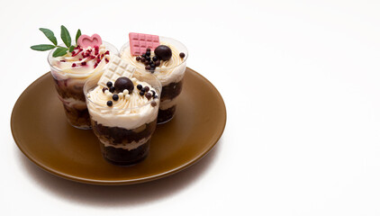 Trifles portioned mini cakes on plate. Layered trifle dessert with whipped cream and chocolate