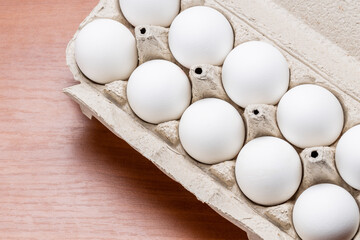 white egg stack at cardboard. above view. easter celebrate concept