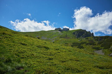 Scenic panoramic view of mountains landscape with blooming meadows