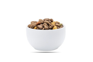 domestic animals dry food at white bowl isolated on white background. dried cat feed cut out. above view