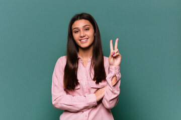 Young Indian woman isolated on blue background showing number two with fingers.