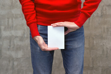 Urinary or prostate problems concept. Young man holds paper above crotch.