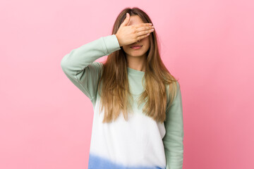 Young woman over isolated pink background covering eyes by hands. Do not want to see something