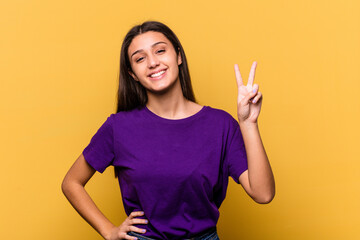 Young Indian woman isolated on yellow background showing number two with fingers.