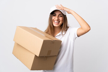 Young delivery woman over isolated white background looking far away with hand to look something