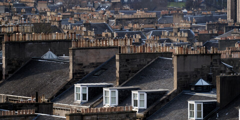 Layers of chimneys on tenement buildings in city