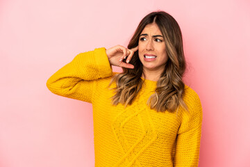 Young caucasian woman isolated covering ears with hands.