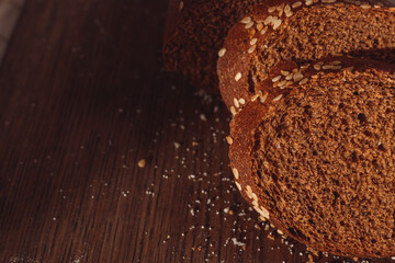 Sliced rye bread on cutting board. Whole grain rye bread with seeds