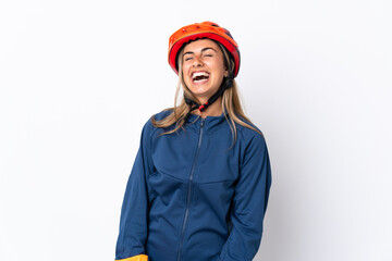 Young hispanic cyclist woman isolated on white background laughing