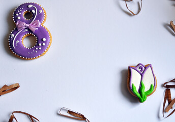 March 8 gingerbread and tulip flowers colorful background.