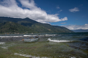 Fototapeta na wymiar boat on the shore of the beach in a beautiful landscape