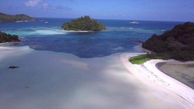 drone flight over Saint-Anne Marine Park with white sandbars, blue sea, green islands