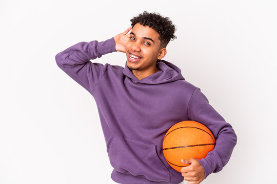 Young African American Curly Man Isolated Playing Basketball Trying To Listening A Gossip.