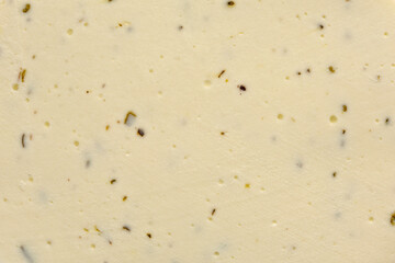 White cheese with provence herbs background or texture.