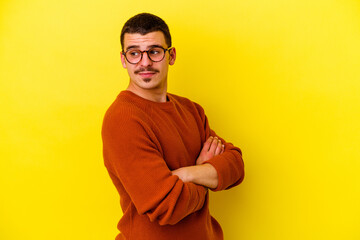 Young caucasian cool man isolated on yellow background dreaming of achieving goals and purposes