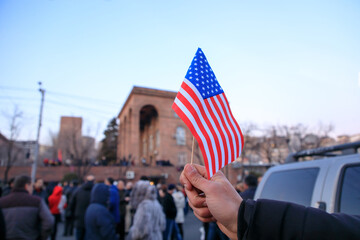 Naklejka premium man holding American flag in the demonstration