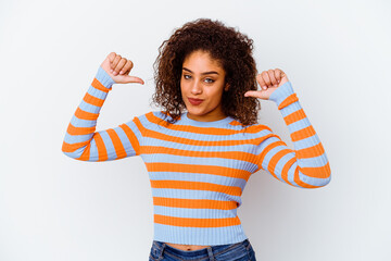 Young african american woman isolated on white background feels proud and self confident, example...