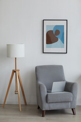 Vertical background image of cozy armchair in minimal home interior, copy space