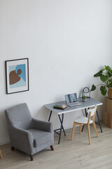 High angle background image of cozy armchair and home workplace in minimal interior, copy space