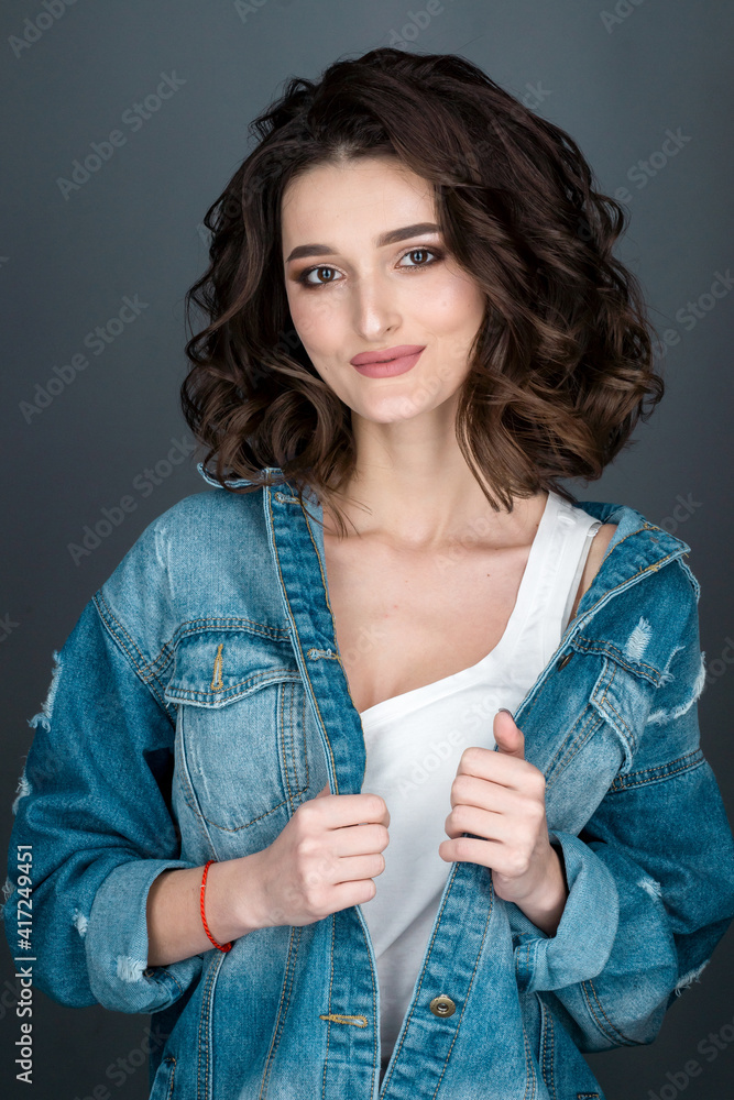 Wall mural close-up portrait of young sexy brunette woman in white underwear and denim jacket