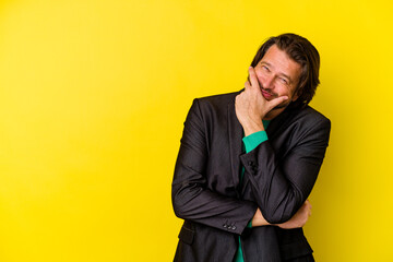 Middle age caucasian man isolated on yellow background laughing happy, carefree, natural emotion.