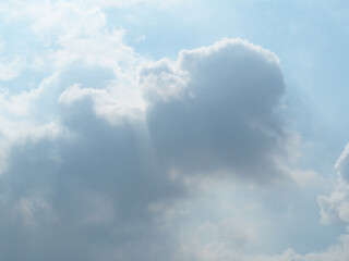 Clouds in the sky and white light shines down.