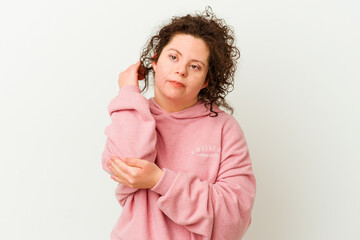 Woman with Down syndrome isolated massaging elbow, suffering after a bad movement.