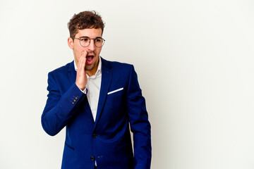 Young business caucasian man isolated on white background is saying a secret hot braking news and looking aside