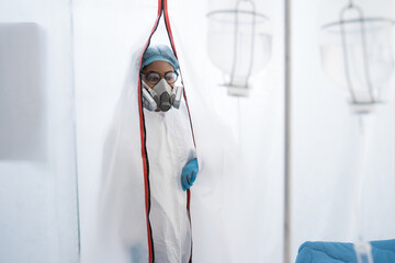 Fototapeta na wymiar Female doctor in a protective cap and face mask in safety measures
