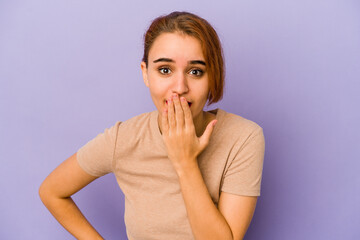 Young arab mixed race woman shocked, covering mouth with hands, anxious to discover something new.